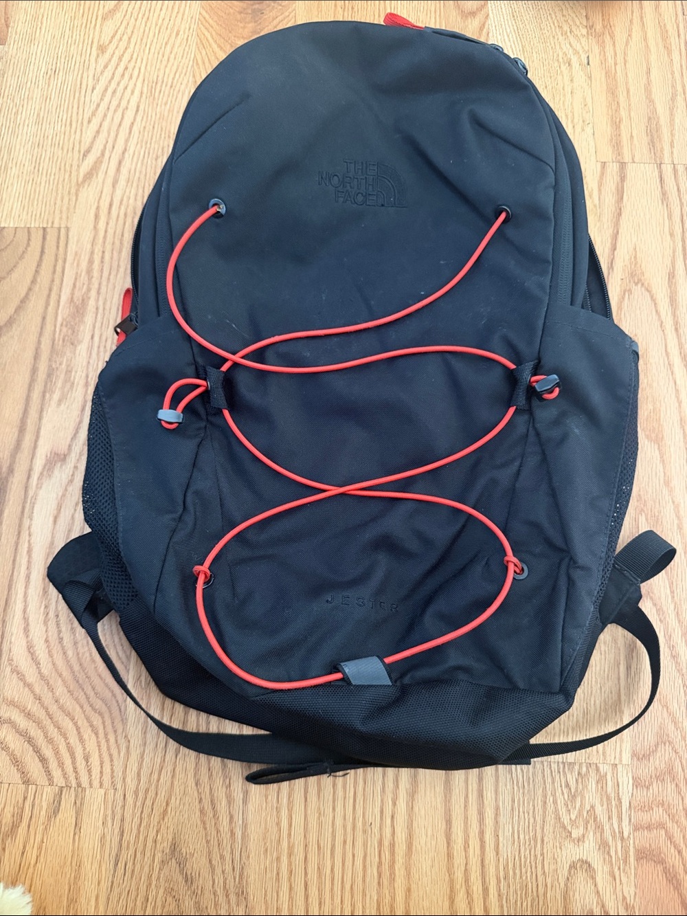 The North Face Black Backpack with Red Bungee Cord